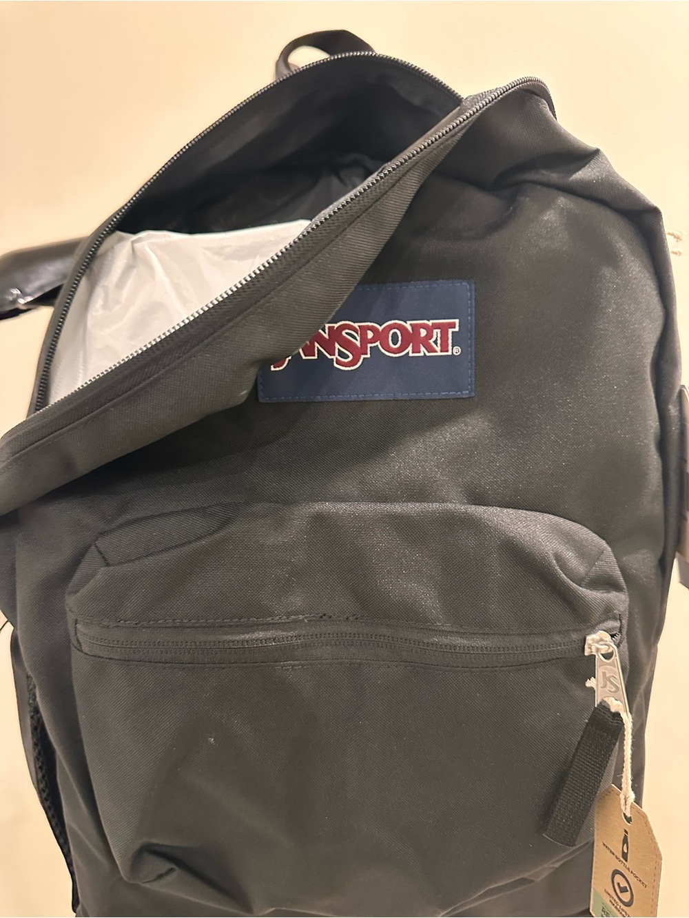 Jansport Black Backpack with Navy Logo Patch and Red Accent
